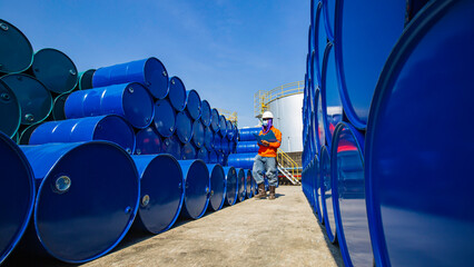 Male worker inspection record drum oil stock barrels blue horizontal or chemical