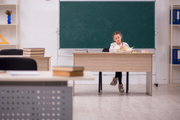 Small girl sitting in the classroom