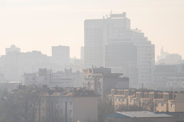 Fototapeta na wymiar Smog lies over the skyline of Historical architecture of Belgrade city. Poor visibility, smog, caused by air pollution. Rooftop view. Emissions of plants and factories. Belgrade, Serbia 21.12.2022 