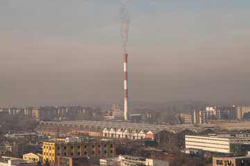 Smog lies over the skyline of Historical architecture of Belgrade city. Poor visibility, smog, caused by air pollution. Rooftop view. Emissions of plants and factories. Belgrade, Serbia 21.12.2022
