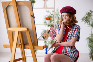 Young girl enjoying painting at home