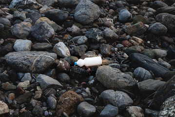 Environmental pollution. White plastic packaging on the seashore