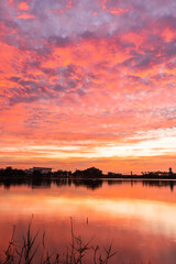 sunset nearly fall from the sky on the horizon reflected into the water