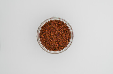 Top of view of granulated coffee in a glass jar with the isolated background. 