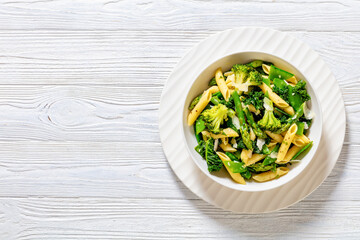 Pasta primavera with green veggies, cheese in bowl