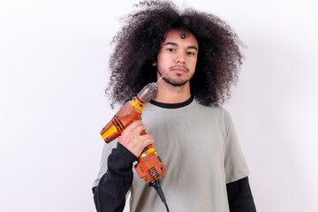 Portrait of the technician with the drill. Young boy with afro hair on white background