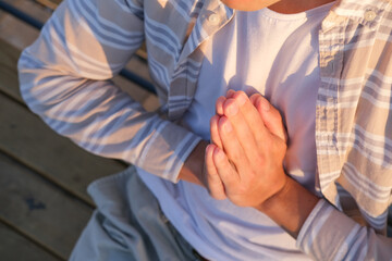 Fototapeta premium Person with hands folded in prayer close up