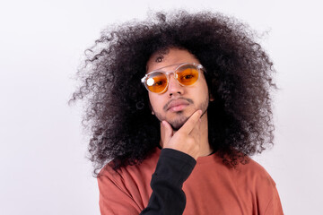 Portrait in sunglasses with seductive look. Young boy with afro hair on white background