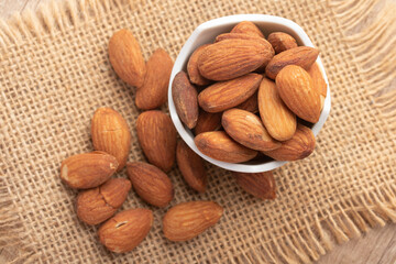 Salted almonds in a white cup.Copy space.