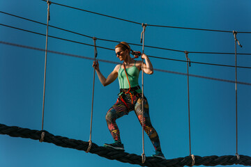 Skilled adult woman in the adventure park