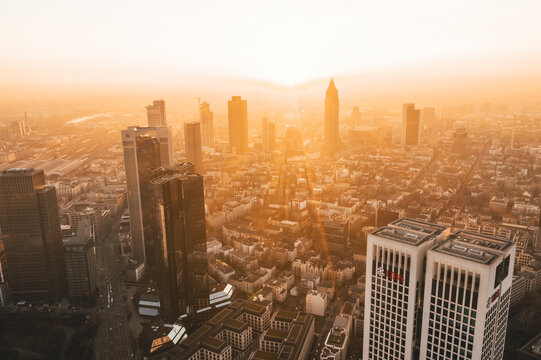 Incredible View of Frankfurt am Main, Germany Skyline in on Hazy Winter morning in Beautiful Sunrise Light