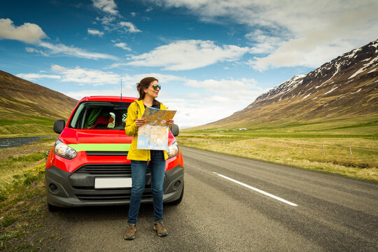 Beautiful woman Finding her way on the map