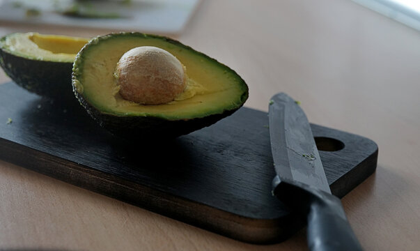 avocado cut on a cutting table. black background