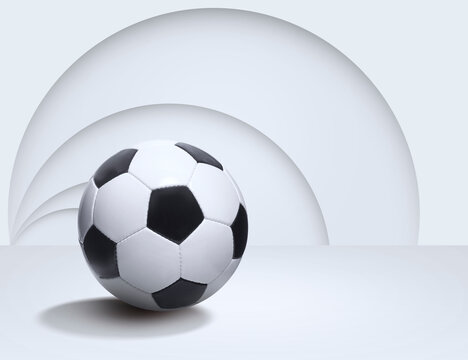 Soccer ball on empty white room with abstract background