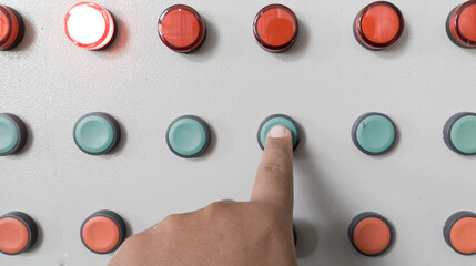 The hand press the push button on the control panel with indicator light for start machine.