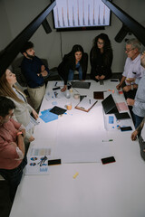 A high view photo of multi-generational group of people working on a new project