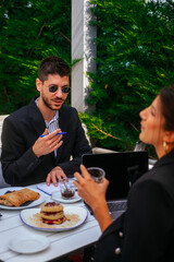 A businessman is explaining to his female partner