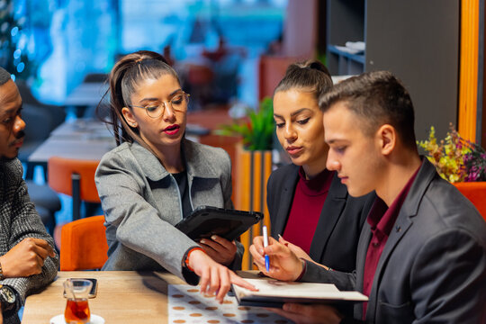 Talking about the company plans and ideas while sitting in the cafe - Powered by Adobe