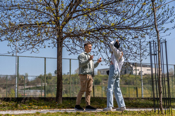 Fototapeta premium Beautiful happy young couple backside outdoors in spring park