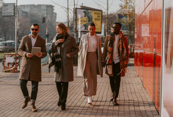 Four business people walking