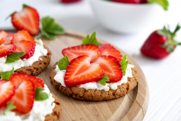 Fototapeta na wymiar Homemade strawberry tart with oat biscuit and whipped cream. Recipe of fast berry cake for breakfast or holiday. Summer light dessert.