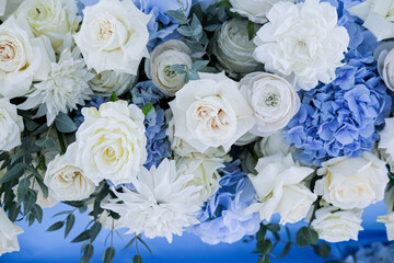 white roses and hydrangeas on a blue tablecloth