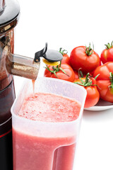 Slow juicer with organic tomatoes isolated on white. Detox diet