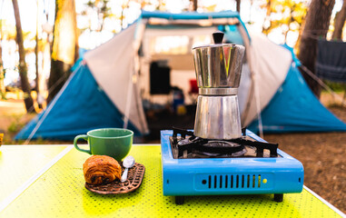 camping holidays in a tent in the middle of the forest italian coffee maker chocolate bread