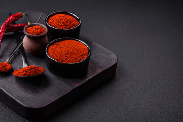 Spice smoked paprika in the form of powder in bowls and spoons