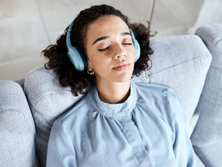 Woman, face and headphones for listening to music for calm, peace and mindfulness on home couch....