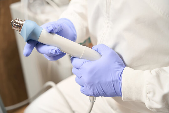 Specialist is using professional shock wave therapy machine in hospital