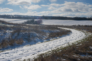 Winter landscape with country road covered with snow near Ivashkove village, Dniproperovsk oblast, Ukraine...
