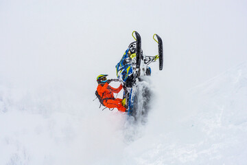 A snowmobile racer in the mountains of a ski resort in Sakhalin, Russia. mountain snowmobile