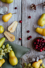 PEARS, GRAPES ON A WOODEN BACKGROUND