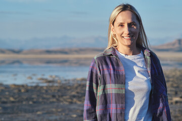 Portrait of blonde woman, early morning at Tuz Kol Lake