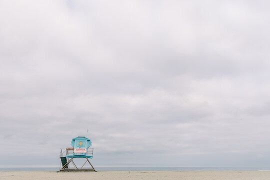 Fine art beach scene with lifeguard Tower and cloudy skies - Powered by Adobe