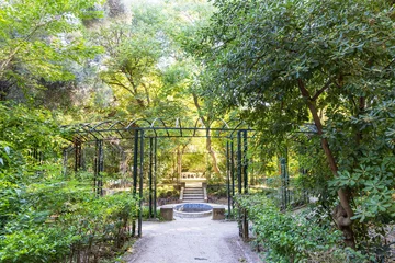 Gartenposter Landscape with overgrown pergola in National garden of Athens in Greece in the center of the city © HildaWeges