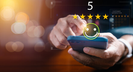 Businessman use smartphone to give five star rating on virtual screen by touching happy face icon