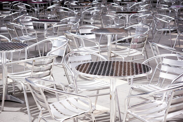 Background of Aluminium tables and chairs set up at an outdoor event