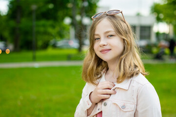 Cute young girl having fun outdoors on sunny summer day.