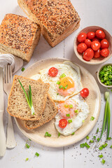 Homemade and healthy breakfast with egg, bread and tomato.