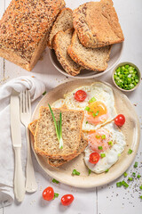 Tasty and fresh breakfast with egg, bread and tomato.