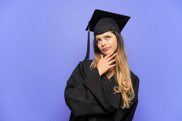 Young university graduate Russian girl isolated on white background looking up while smiling