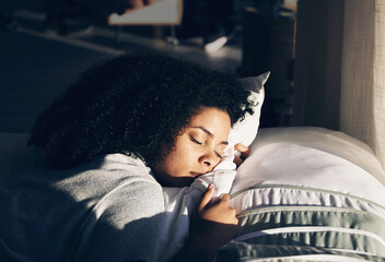 Black woman, sleeping in bed for peace, quiet and rest or relax in home bedroom. Person with pillow...