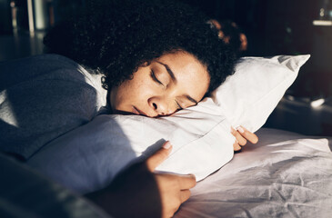 Black woman, sleeping and pillow in morning for peace, quiet and rest or relax in home bedroom. Person on bed to dream or for calm sleep with sleepy or stress relief for health and wellness