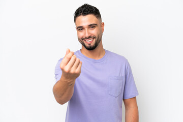 Young Arab handsome man isolated on white background making money gesture