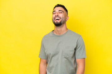 Young Arab handsome man isolated on yellow background laughing