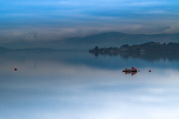 Misty Loch Lomond with distant water ski