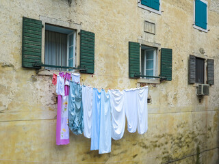 Colourful clothes on building washing line