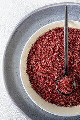 Red wine flavored salt in a bowl. Gourmet condiment to aromatize and season food Dessert, Seafood, Meats, Pasta, Sauce, Finishing Salt